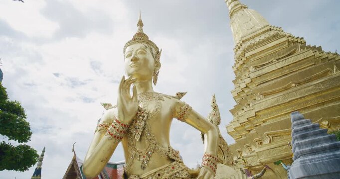 Wat Phra Kaew Temple that houses an ancient Emerald Buddha with golden angel Bangkok Thailand
