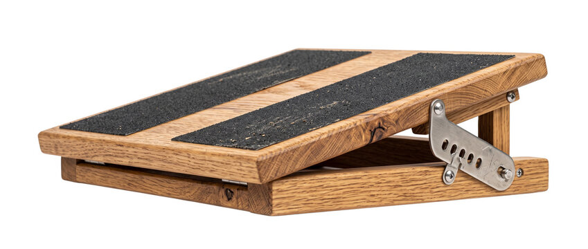 Wooden slant board foot stretcher with adjustable incline metal hinge and non slip grip tape for calf stretching physical therapy exercise and fitness training isolated on black background studio shot
