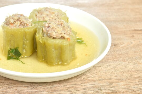 boiled bitter melon stuffed mased pork and glass noodles clear soup on plate
