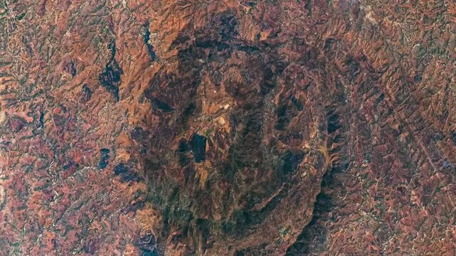 Aerial view on extinct volcano, shattered relief. Camera is moving backward and right. Animation based on image by NASA