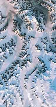 Panoramic shot on nunataks, glaciers and snow. Camera is moving backward. Vertical video. Animation based on image by NASA
