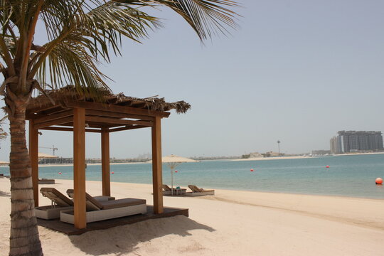 Luxury beach resort with palm trees and cabanas overlooking the sea in Dubai