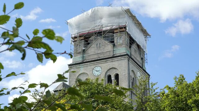 Historic stone church tower undergoing restoration work