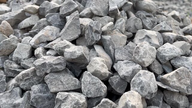 Pan shot of coarse aggregate gravel pile for concrete mixing building material