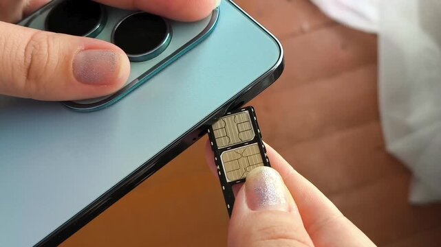 Close up of woman installing SIM card in smartphone, cellular service, mobile communication and internet connection.
