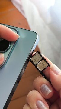Woman inserting SIM card into smartphone, mobile connectivity, cellular network and mobile internet concept.