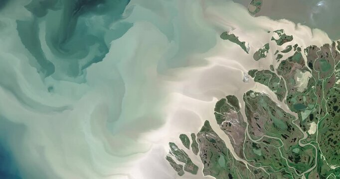 Panoramic top view of big delta of a river flowing into the sea. Camera is moving right. Animation based on image by NASA