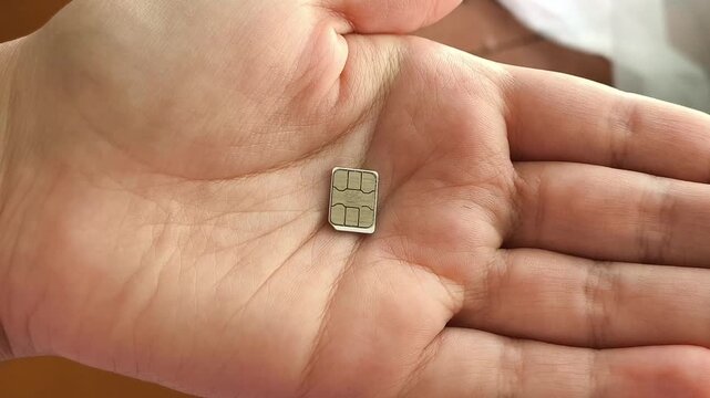 SIM card in hand, mobile internet, cellular connection, international roaming and telecommunications concept.