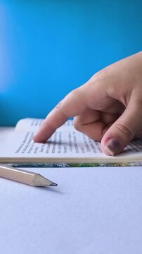 Student reading a book at table, school education, reading literature and academic learning concept.