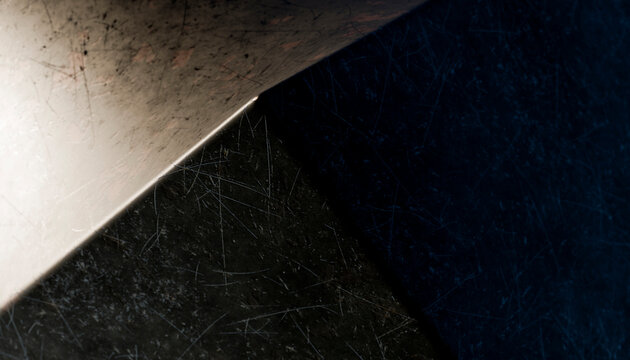 Close-up view of a scratched metal sheet corner with detailed texture
