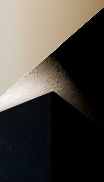 Close-up of scratched metal cube under contrasting light and shadow