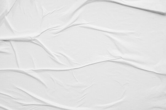 white crumpled and creased glued wrinkled paper poster texture background