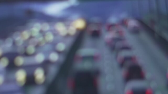 Blurry highway traffic jam at night with cars and city lights creating a beautiful bokeh effect creating an abstract background