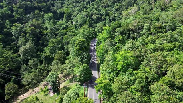 Cinematic Aerial View of a Mountain Road Hidden Within Tropical Forest in Sumatera