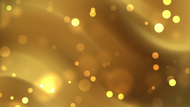 Golden bokeh particles dance in this bright abstract background of glowing light.