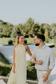 Couple enjoys a sunny day walking through a beautiful garden setting