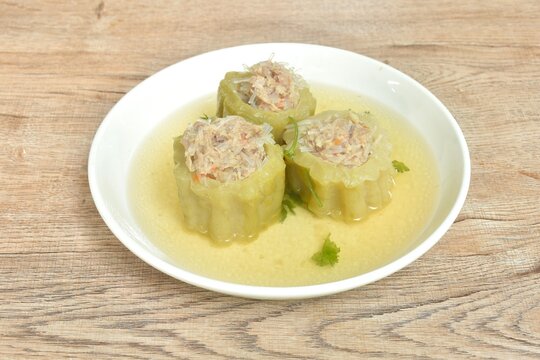 boiled bitter melon stuffed mased pork and glass noodles clear soup on plate