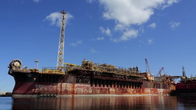 Huge rusty fpso vessel moored in a port