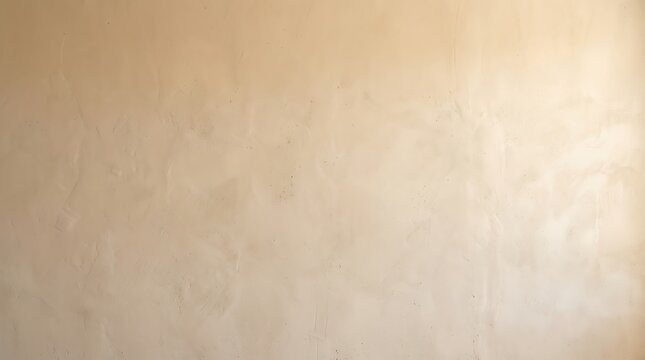 Close-up view of a subtly textured beige wall with uneven lighting.