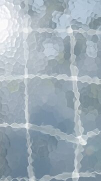 Abstract textured frosted glass with hexagonal faceted pattern and blurred green tree reflections behind creating a calming architectural aesthetic