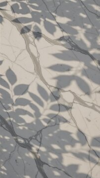 Elegant moving shadows of tropical leaves cast on a white marble surface with grey veining creating a minimal sophisticated aesthetic