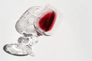 Overhead Flat Lay of Wine Glasses with Red Wine and Dramatic Crystal Shadow Reflections on White Background, Abstract Art Photography © Anastasia