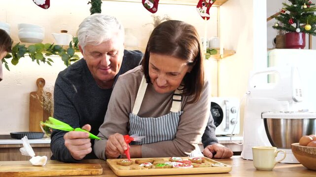 The family parents and daughter do activities together, decorating gingerbread cookies with cream cheese, piping Santa-themed decorations, and preparing food for Thanksgiving and Christmas. 