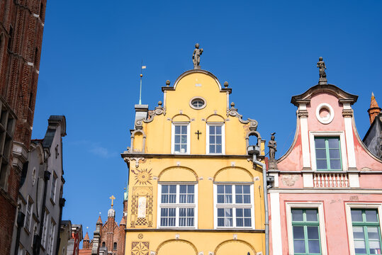 Detailed view of ornamented historic townhouse facades and decorative gables in the old town area of Gdansk, Poland on a bright sunny day.