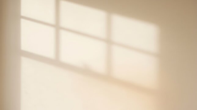 Warm sunlight casting a geometric window shadow pattern on a beige wall, creating a serene and minimalist aesthetic.