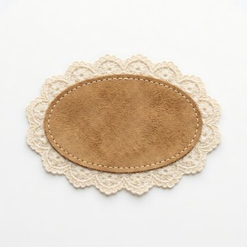 Oval suede leather coaster with decorative lace border isolated on white background
