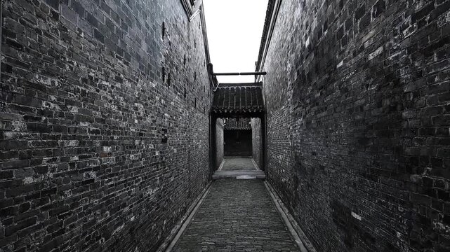 Narrow ancient alley with weathered brick walls in Chinese historic town