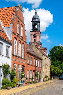 Friedrichstadt, Germany - Historic brick houses with a view of the distinctive Remonstrant church tower