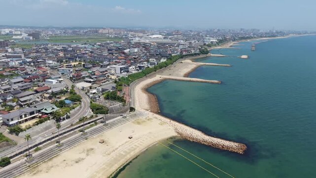 Aerial Drone Orbiting over Sea along Coastal Town, Hyogo, Japan