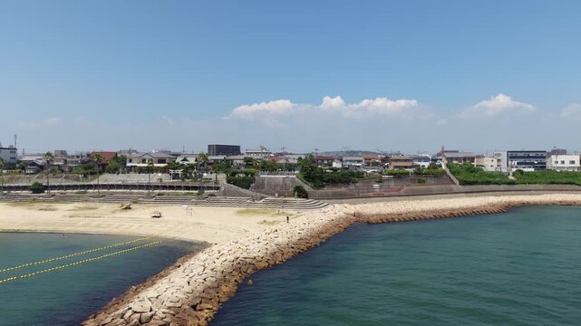 Aerial Drone Rising and Pulling Back Revealing Coastal Town and Sea, Hyogo, Japan