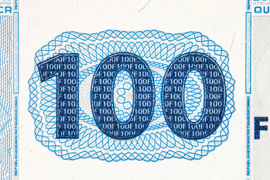 Extreme macro detail of the denomination number 100 Congolese Francs banknote, showing fine intaglio print texture and protective background lines. Money of Africa.