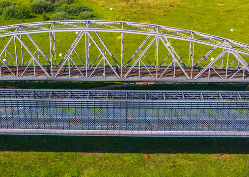 Aerial view of the historic Tczew Bridge with its intricate steel truss structures and metal lattice work spanning over the riverbanks in Tczew, Pomeranian Voivodeship, Poland.