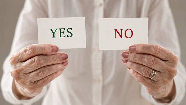 hands holding decision cards with yes and no text presented by a senior woman in white, illustrating agreement versus refusal, decision making, binary choice, consent, response and options
