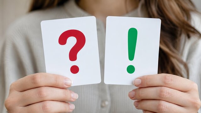 hands holding decision cards with red question mark and green exclamation mark, illustrating uncertainty versus solution, problem solving, answer, decision making, insight, clarification and choice