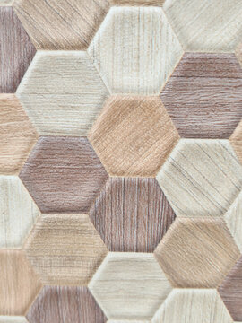 High-resolution commercial backdrop featuring 3D hexagonal ceramic tiles with natural wood grain patterns in warm brown and neutral beige tones. Geometric wall panel background designed