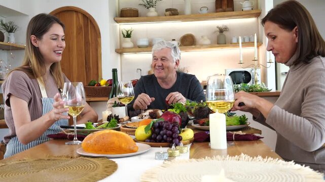 The family had a Christmas and Thanksgiving party. The daughter cooked, served wine, and grilled chicken. The parents chatted and enjoyed themselves at the dinner table, eating grilled chicken at home