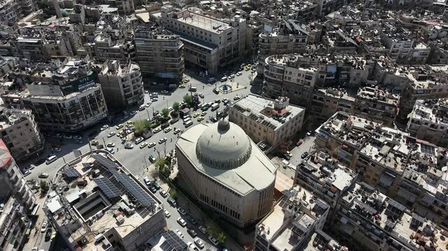 Aerial drone view of a church and Christian worshipers gathering in Syria. Weekly prayers and religious minorities in the Middle East. Golden dome and religious architecture.