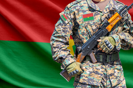 Burkina Faso flag with soldier holding assault rifle