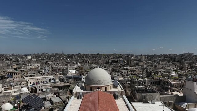 Aerial drone view of a church and Christian worshipers gathering in Syria. Weekly prayers and religious minorities in the Middle East. Golden dome and religious architecture.