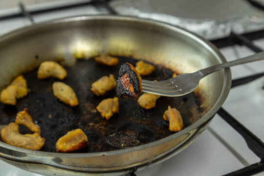 Burnt Food in Frying Pan with Fork