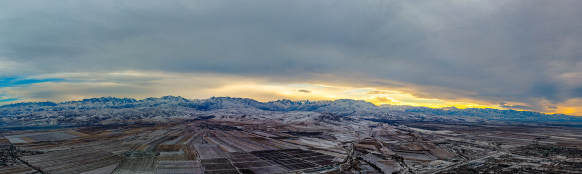 Aerial View of Snow-Covered Mountains and Fields in Kyrgyzstan