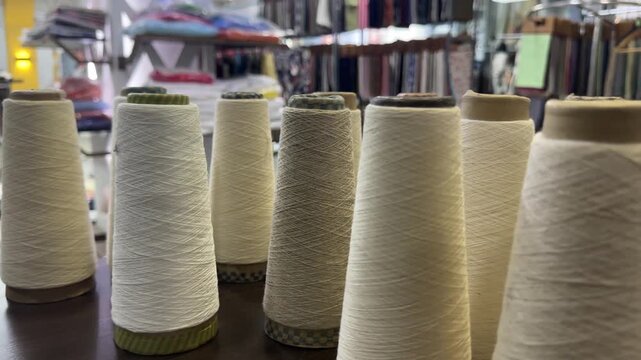 Cotton yarn cones arranged in a textile manufacturing facility