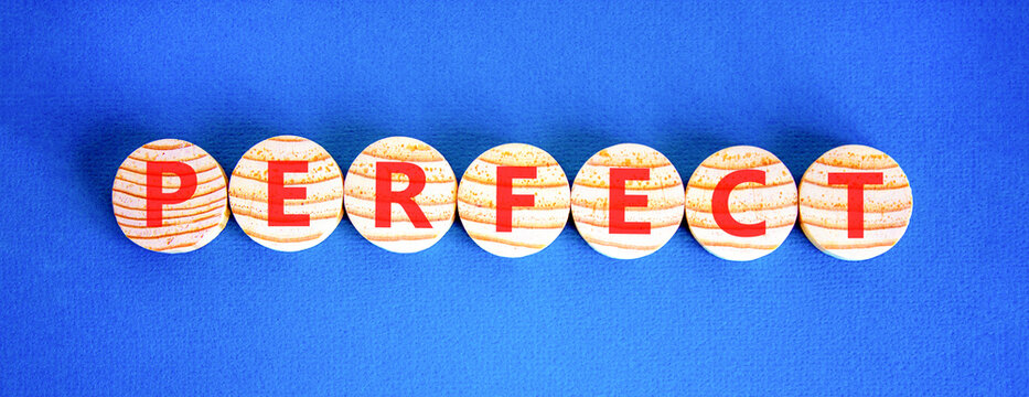 Perfect word symbol. Concept word Perfect on beautiful wooden circles. Beautiful blue background. Business perfect word concept. Copy space.