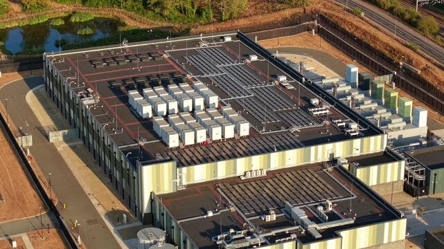 Aerial View of Hyperscale Data Center Rooftop with Cooling Units, Air Handlers and Solar Panels for AI Tech