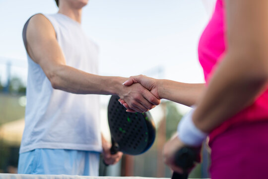 Padel players shaking hands showing sportsmanship after game