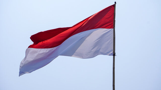 Indonesian flag red and white fluttering high against a bright blue sky for the 81st Independence Day.